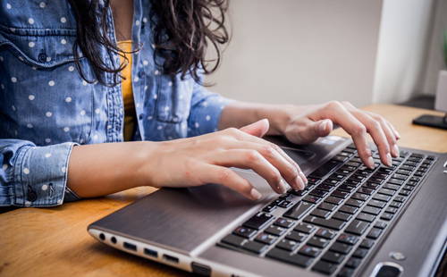 female at computer keyboard image