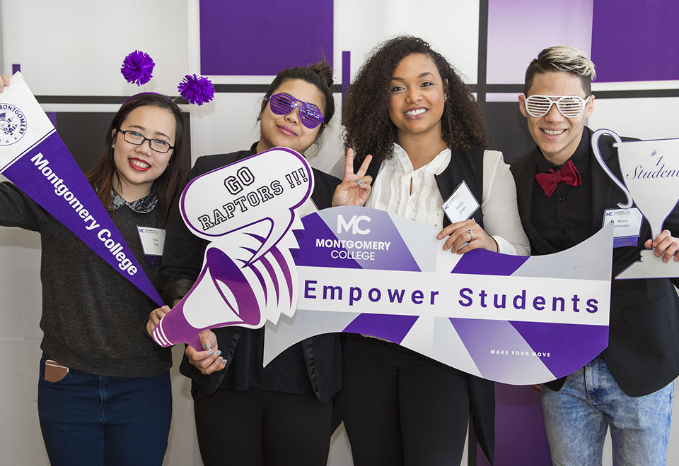 students dressed for photo booth with signs about student empowerment